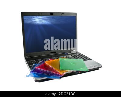 Colored cd`s on a laptop isolated. Nice rays of light on desktop Stock Photo